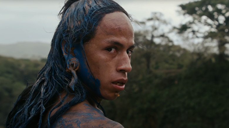 Rudy Youngblood as Jaguar Paw looks over his shoulder in the jungle in Apocalypto