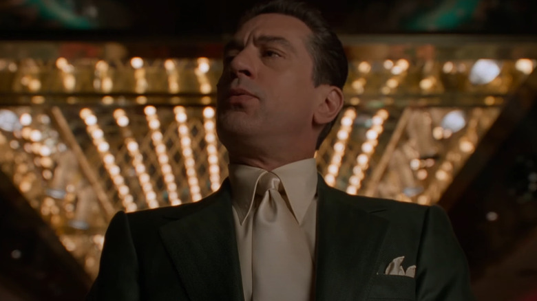 Robert DeNiro as Sam "Ace" Rothstein stands in front of a casino.