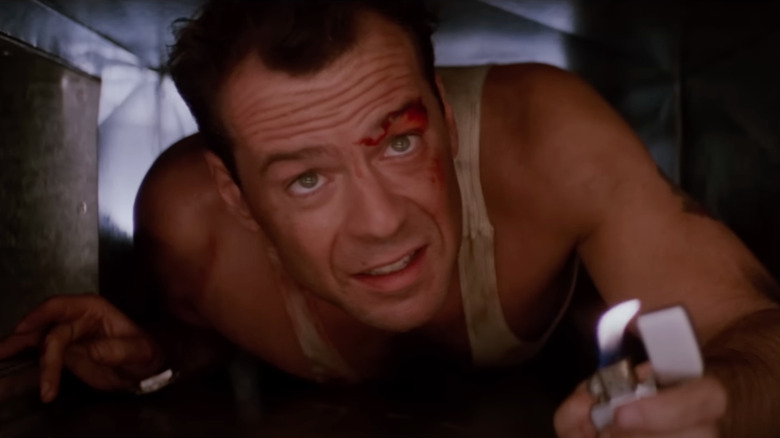 Bruce Willis as John McClane climbs through a narrow air duct in Die Hard