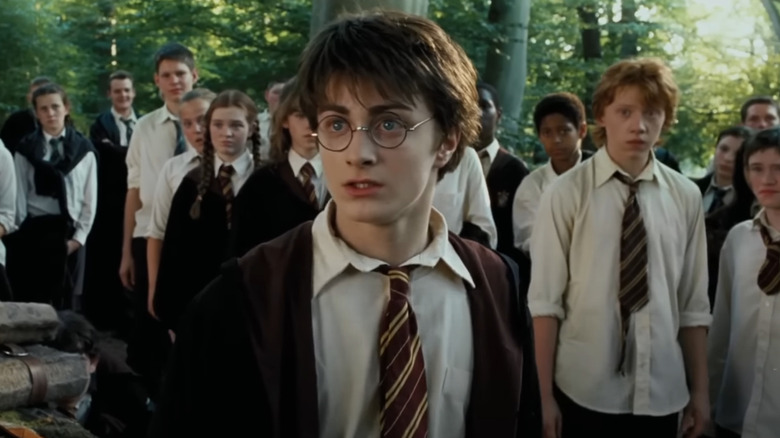 Daniel Radcliffe as Harry Potter looks worried in front of his classmates, including Rupert Grint as Ron Weasley in Prisoner of Azkaban