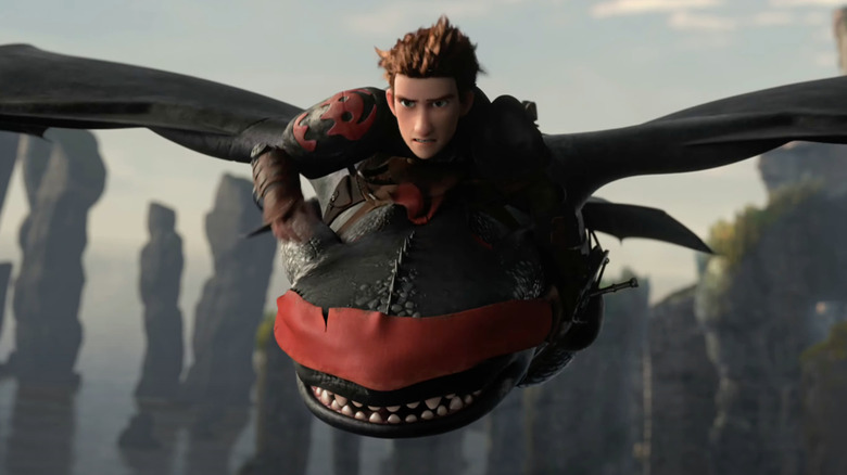 Jay Baruchel as Hiccup flies atop a blindfolded Toothless in How to Train Your Dragon 2