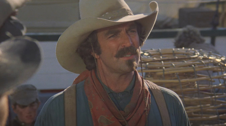 Tom Selleck as Quigley walks through a busy town in Quigley Down Under