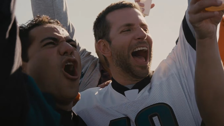 John Ortiz as Ronnie and Bradley Cooper as Pat Solitano cheer on the Eagles with their friends in Silver Linings Playbook