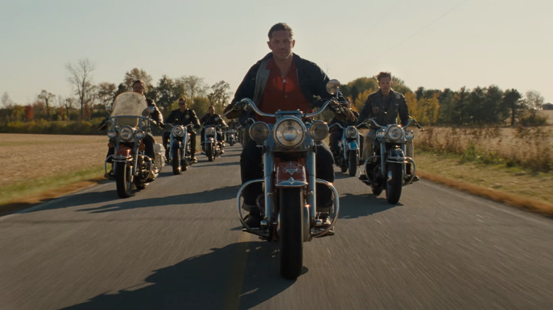 Tom Hardy as Johnny leads his biker gang down a country road in The Bikeriders