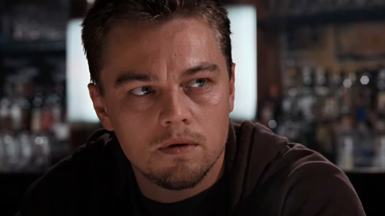 Leonardo DiCaprio as Bill Costigan looks concerned in a restaurant in The Departed