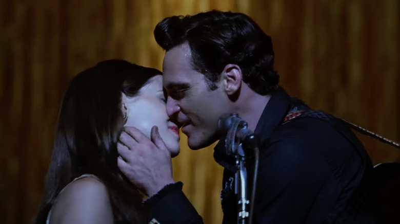 Reese Witherspoon as June Carter and Joaquin Phoenix as Johnny Cash share a kiss on stage in Walk the Line