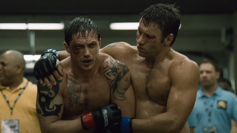 Tom Hardy as Tommy Conlon and Joel Edgerton as Brendan Conlon embrace after a fight in Warrior