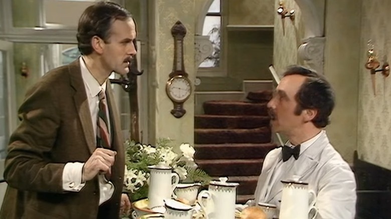 Fawlty Towers' Basil arguing with Manuel while he carries a tray