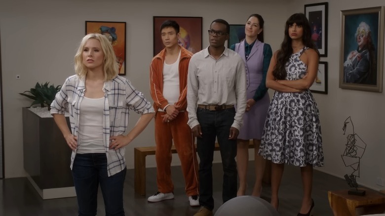 The Good Place's Jason, Chidi, Janet, and Tahani standing together with Eleanor standing in front