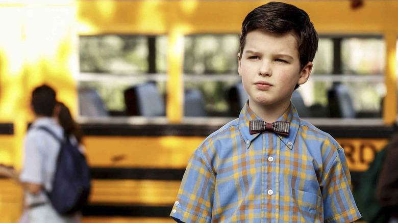 Young Sheldon in front of a school bus