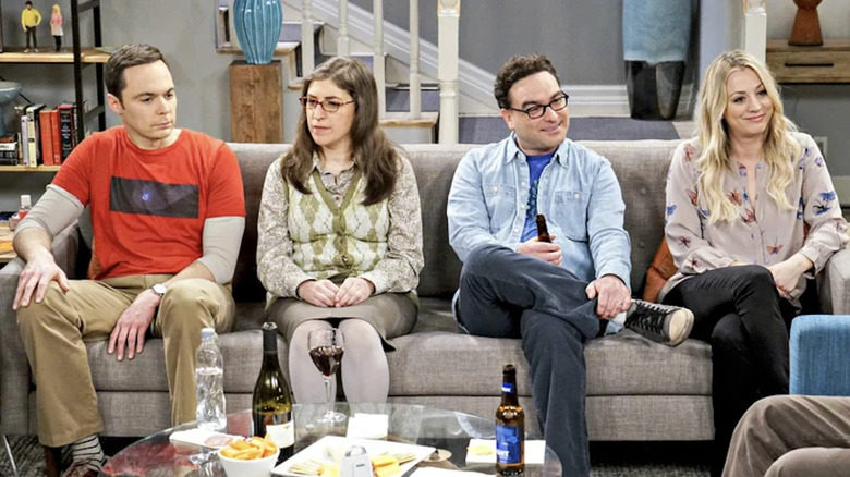 Sheldon, Amy, Leonard, and Penny sitting awkwardly on the couch on The Big Bang Theory