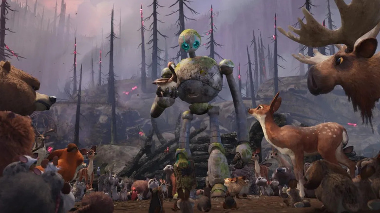 Roz and Brightbill, surrounded by woodland animals in a burned-out forest in The Wild Robot