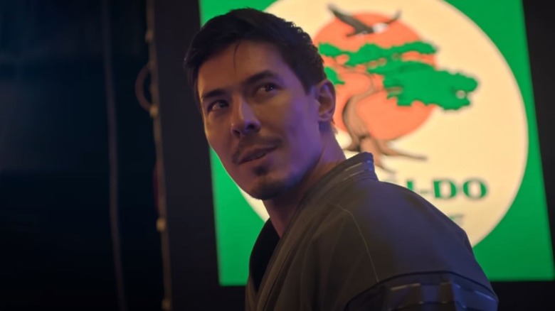 Lewis Tan as Sensei Wolf looking mischievous on Cobra Kai