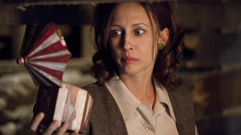 Vera Farmiga as Lorraine Warren holding a music box in The Conjuring