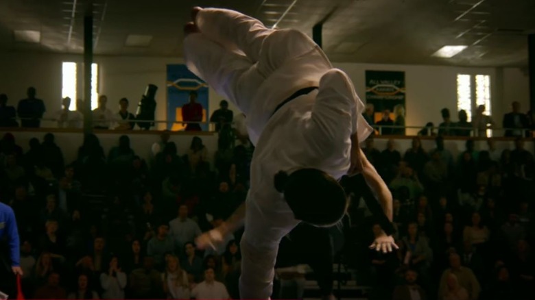 Tanner Buchanan's Robby Keene executing a two-legged kick on Cobra Kai