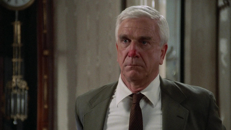 Leslie Nielsen as Lt. Frank Drebin, with a red nose in The Naked Gun: From the Files of Police Squad