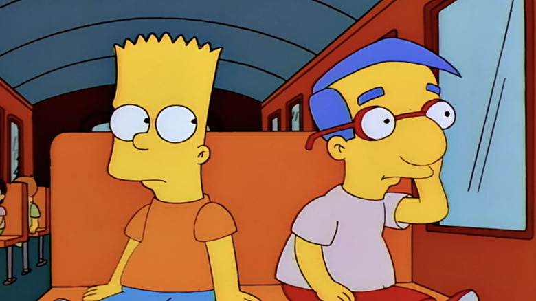 Bart sits next to a forlorn Milhouse on the schoolbus in The Simpsons