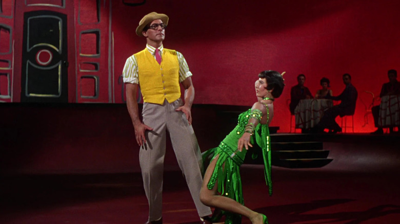 Don Lockwood, in the middle of a red-hued dream ballet, is seduced by a dancer in a green dress.