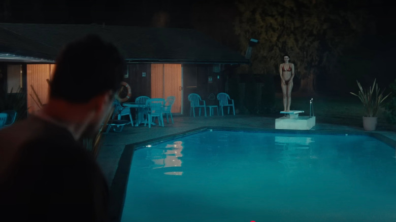 Theo James as Hal looks on helplessly as Corin Clark's swimmer dives into an electrified pool