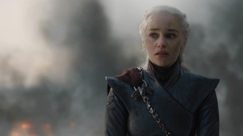 Daenerys on dragonback covered in soot staring and angry in Game of Thrones