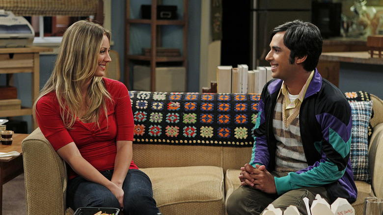 Penny Raj smiling on couch Big Bang Theory