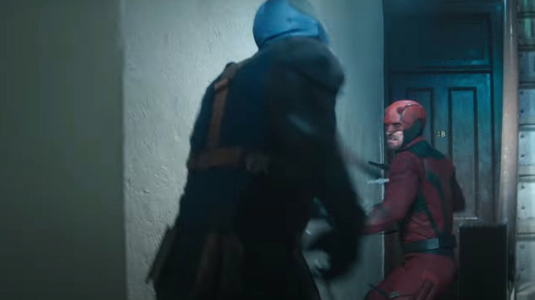 Daredevil and Bullseye fighting in an apartment complex hallway