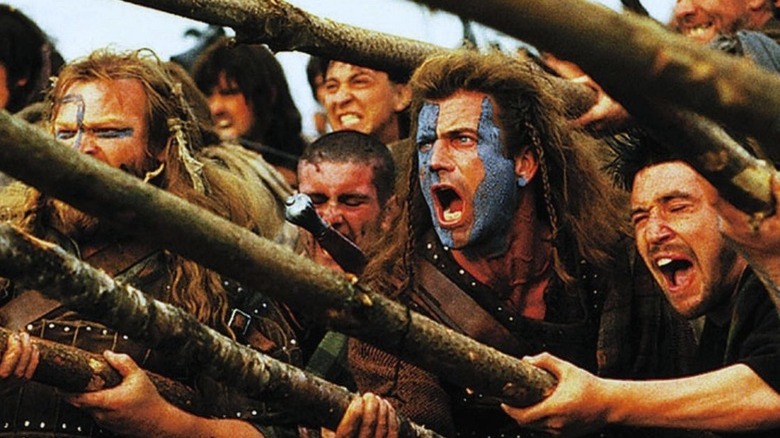 Mel Gibson as William Wallace yells among a crowd of warriors