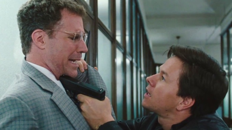 Mark Wahlberg holds Will Ferrell at gunpoint.