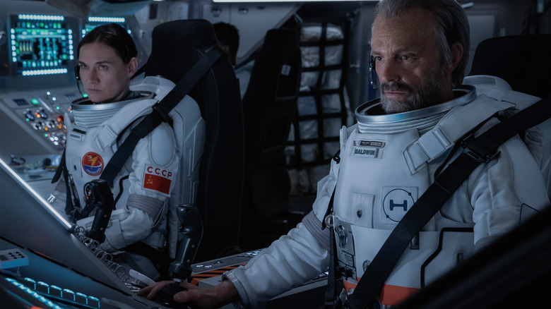 Masha Mashkova as Cosmonaut Svetlana Zakharova and Joel Kinnaman as astronaut Edward Baldwin at the controls of a starship in For All Mankind