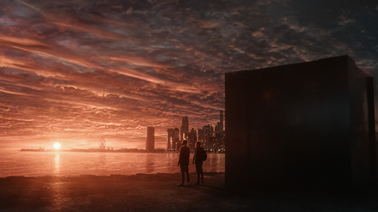 Dayo Okeniyi as Leighton Vance and Joel Edgerton as Jason Dessen with a dazzling sunset in the background and the multiverse machine in the foreground in Dark Matter