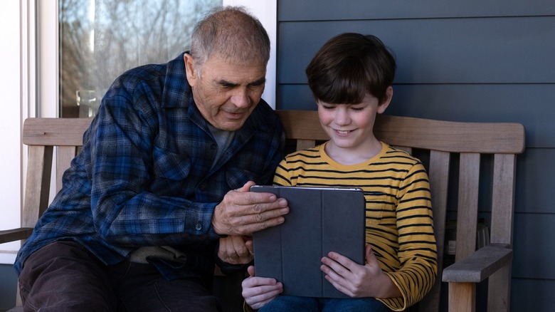 Joe and Dylan reading off a Tablet in "Amazing Stories"