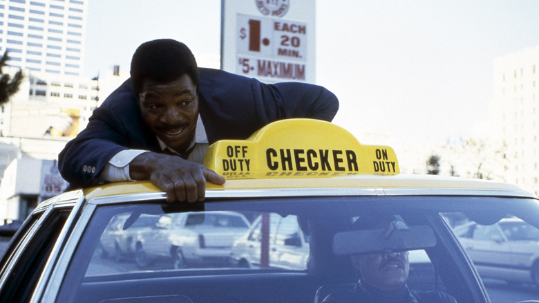 Carl Weathers surfing a taxi