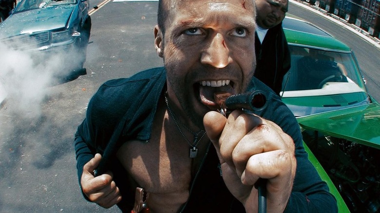 Jason Statham clamping his tongue with jumper cables