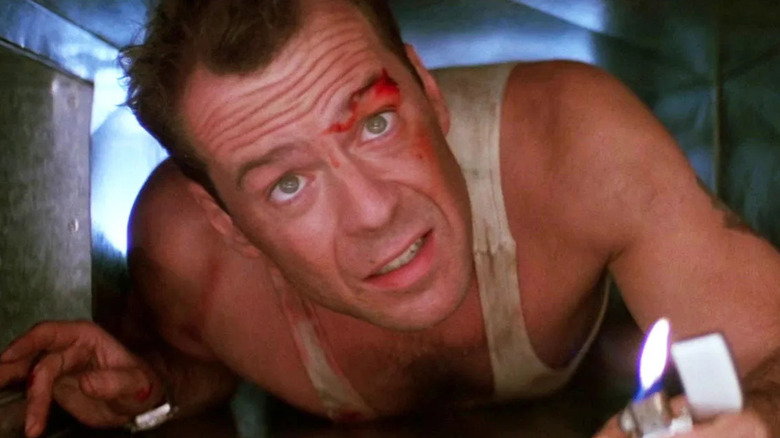 Bruce Willis crawling through an air vent