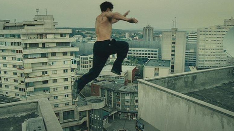 David Belle jumping between Parisian rooftops