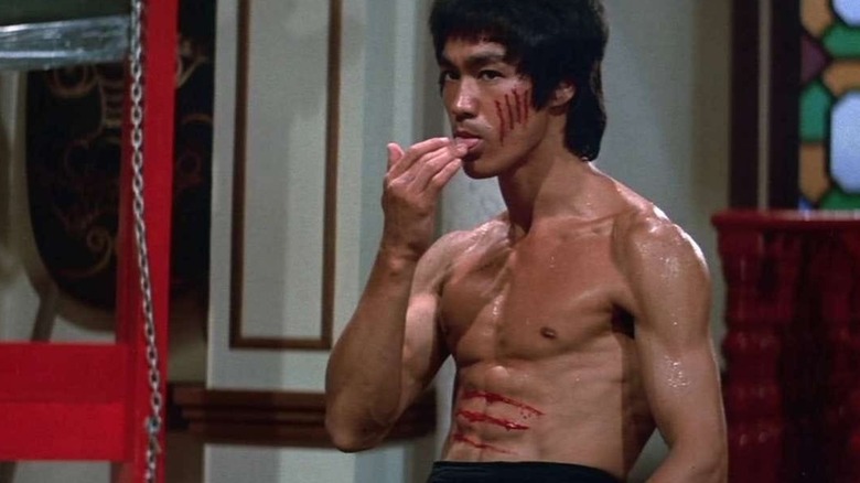 Bruce Lee licking his wounds before finishing a fight