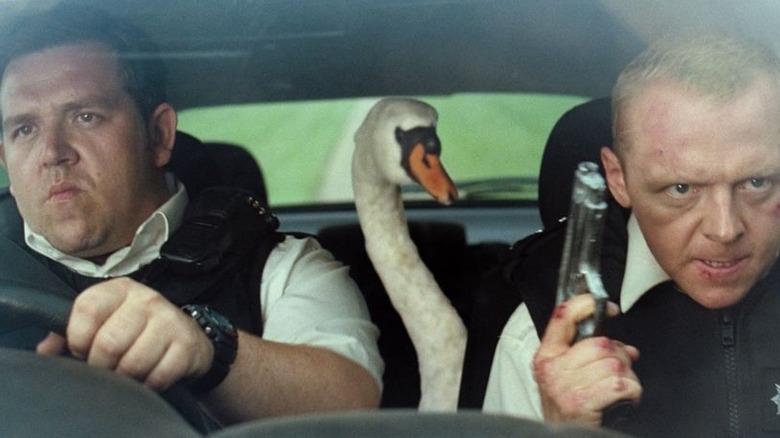 Nick Frost, a goose, and Simon Pegg in a squad car