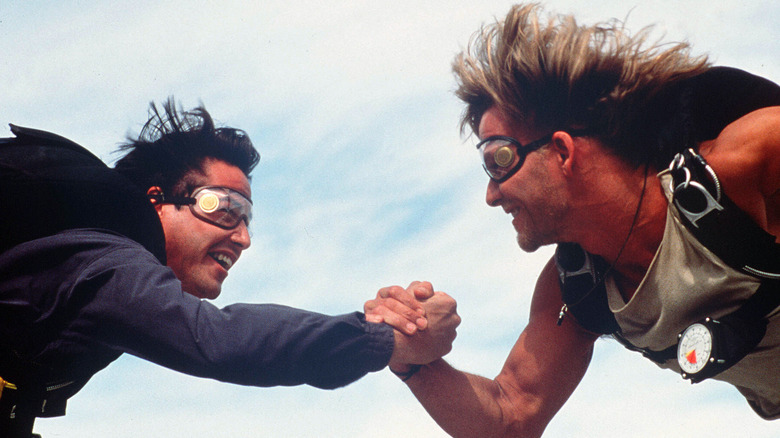 Keanu Reeves and Patrick Swayze locking hands mid-skydive