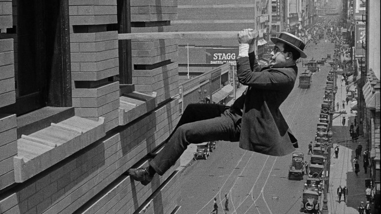 Harold Lloyd hanging on for dear life to the side of a high-rise