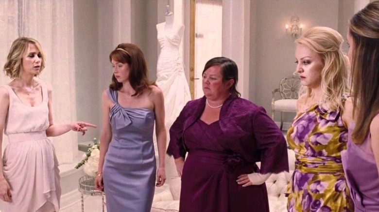 Bridesmaids trying on dresses