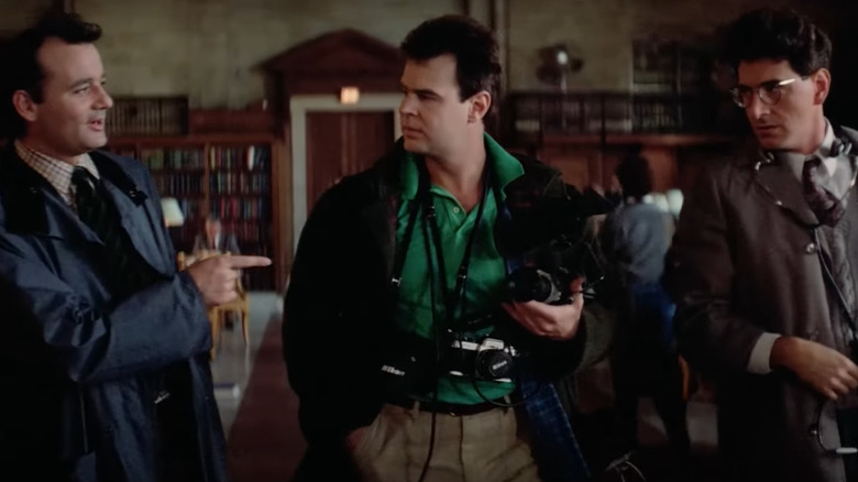 Murray, Aykroyd, and Ramis in library