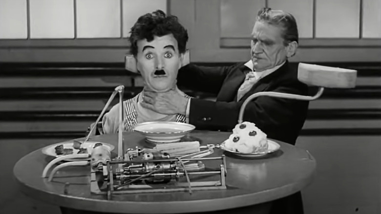 Charlie Chaplin strapped into breakfast machine