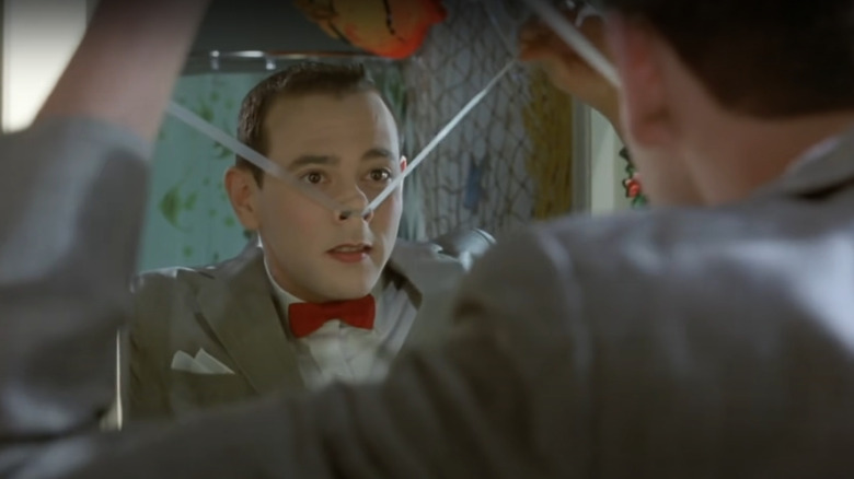 Pee Wee Herman taping up his nose