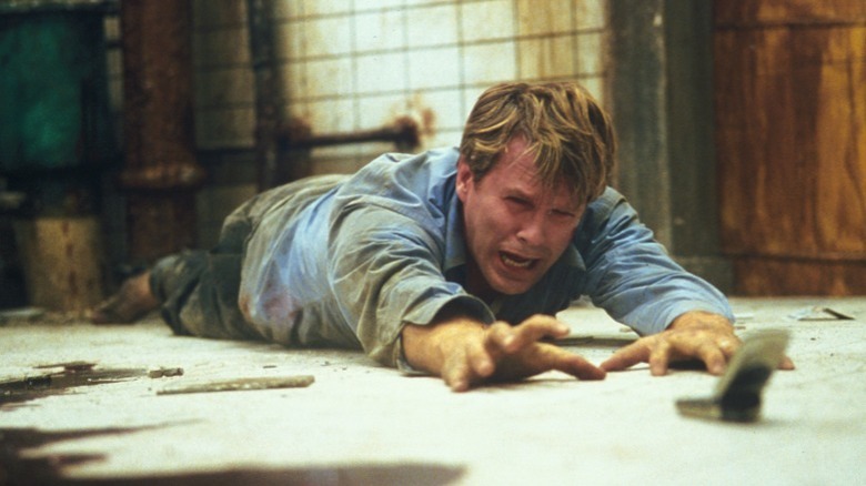 Cary Elwes reaches for phone in Saw