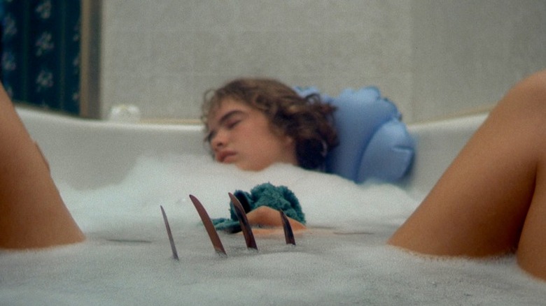 Freddy Krueger claws a girl in the bath
