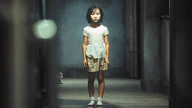 Young girl stands alone in hallway in Dark Water