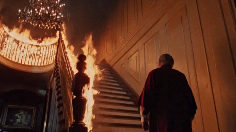 George C. Scott climbs burning staircase in The Changeling 