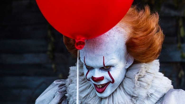 Pennywise holds balloon in It