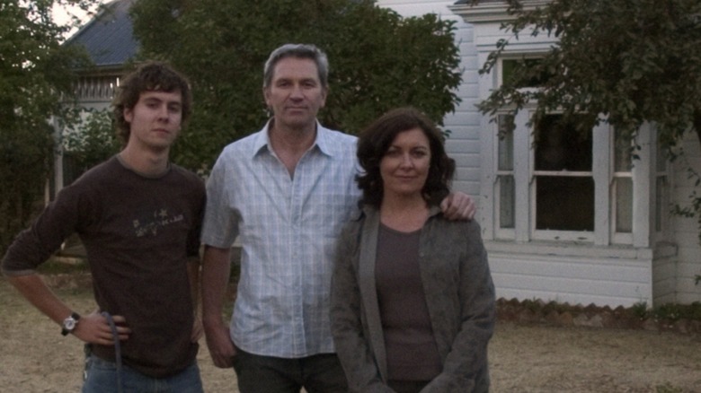 The Palmer family stands in front of their home