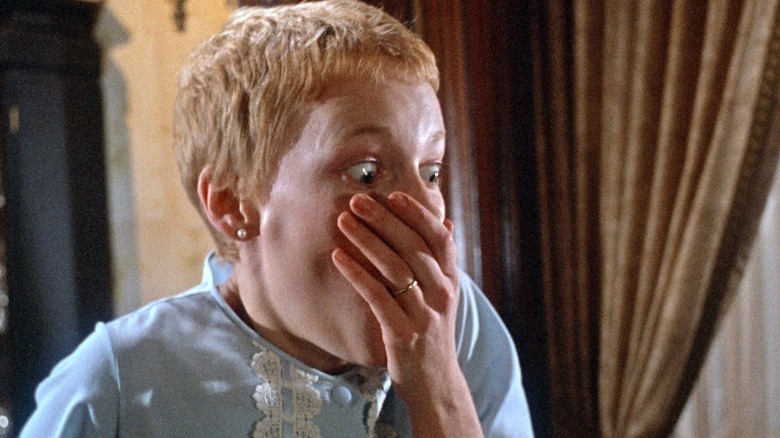 Woman covers mouth and screams in Rosemary's Baby